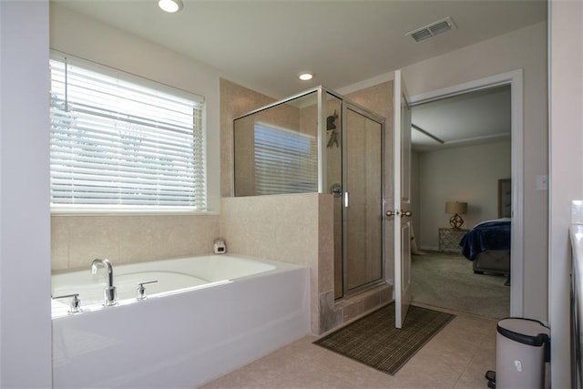 bathroom with separate shower and tub and tile patterned flooring