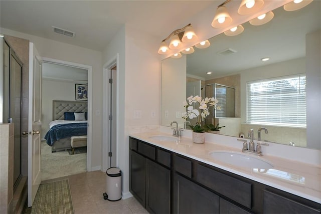 bathroom with tile patterned flooring, vanity, and walk in shower