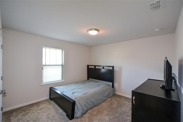 bedroom with light colored carpet