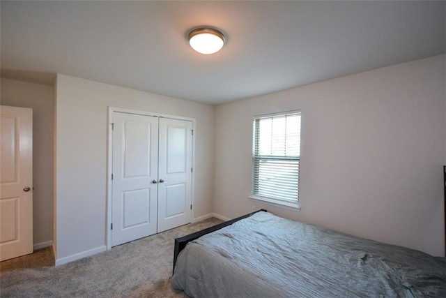 carpeted bedroom with a closet