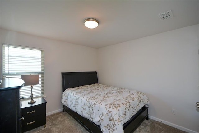 bedroom with carpet floors and multiple windows