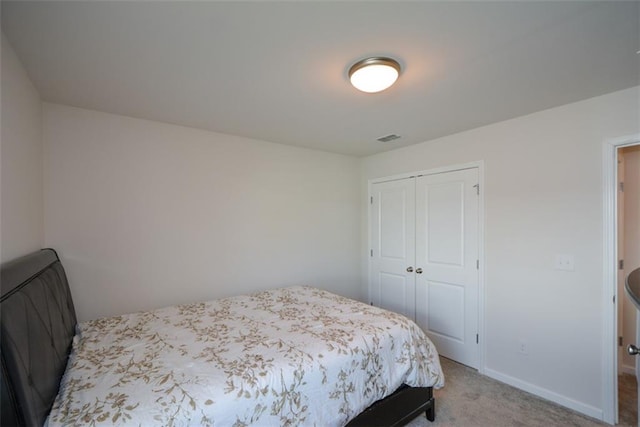 bedroom with carpet flooring and a closet