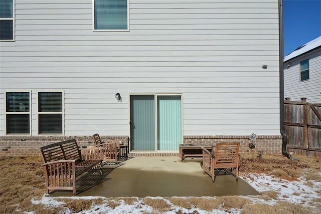 snow covered house with a patio area