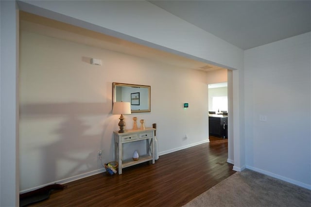 hallway with dark hardwood / wood-style floors