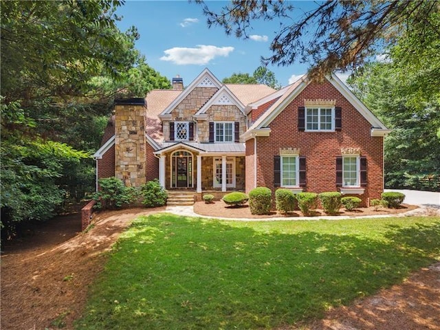 view of front of property featuring a front yard and french doors