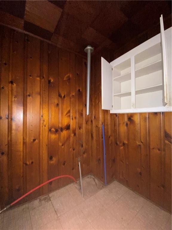 interior space featuring wood walls and light floors