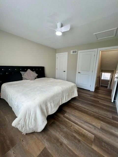 bedroom with dark wood-type flooring and ceiling fan