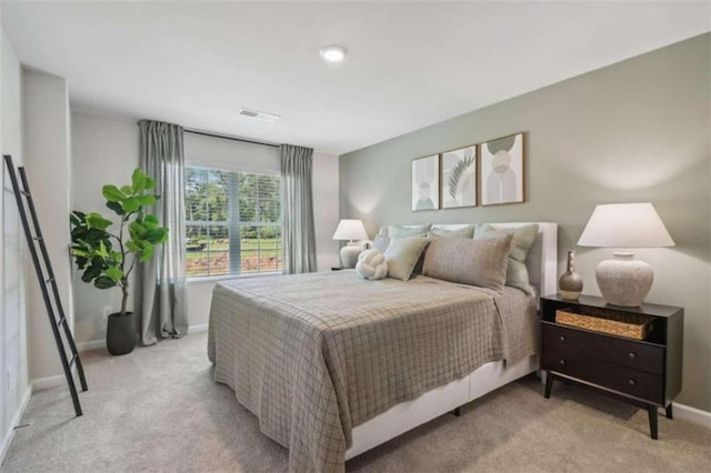 bedroom featuring light colored carpet