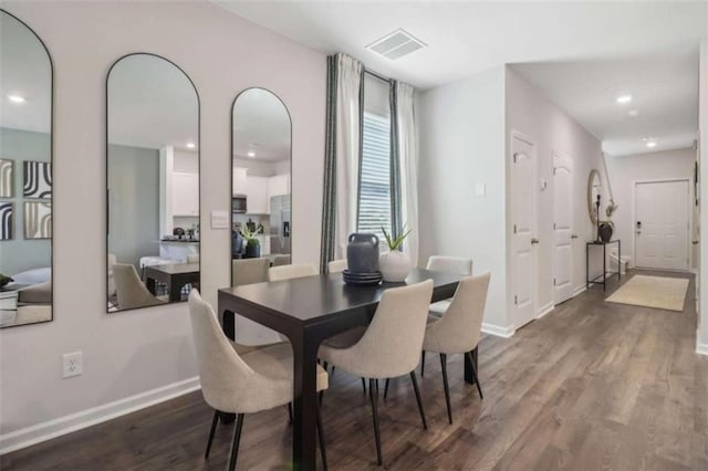 dining space with hardwood / wood-style floors