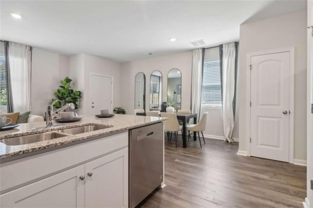 kitchen featuring sink, white cabinetry, dishwasher, dark hardwood / wood-style flooring, and light stone countertops