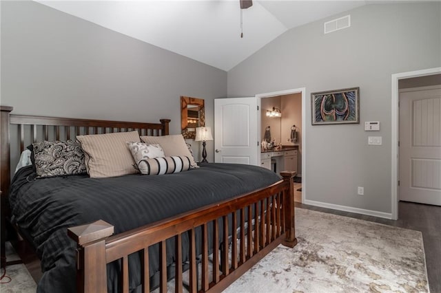 bedroom with connected bathroom, light wood-style flooring, visible vents, baseboards, and vaulted ceiling