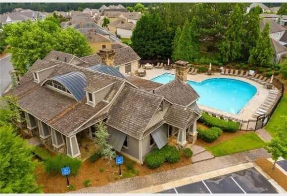 community pool featuring fence and a patio