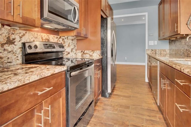 200 Renaissance Pkwy NE Unit 304, Atlanta, GA 30308 - kitchen featuring appliances with stainless steel finishes, a sink, and brown cabinetry