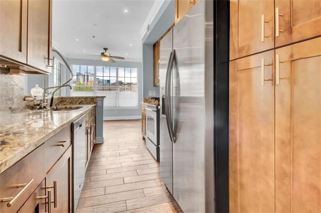 200 Renaissance Pkwy NE Unit 304, Atlanta, GA 30308 - kitchen featuring stainless steel appliances, a sink, ceiling fan, light wood finished floors, and light stone counters