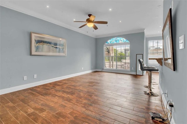 200 Renaissance Pkwy NE Unit 304, Atlanta, GA 30308 - unfurnished living room featuring crown molding, a ceiling fan, wood finished floors, baseboards, and recessed lighting