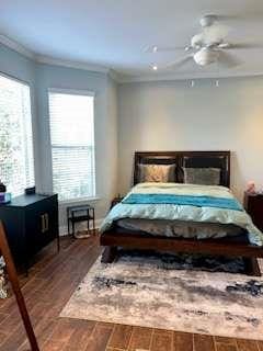 200 Renaissance Pkwy NE Unit 304, Atlanta, GA 30308 - bedroom with crown molding, multiple windows, dark wood finished floors, and ceiling fan