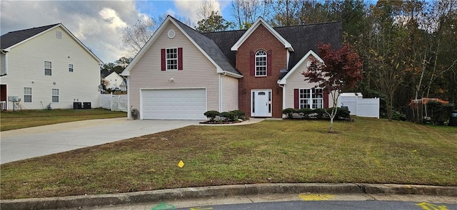 front of property with a front yard, a garage, and cooling unit