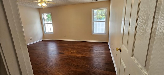 unfurnished room featuring a textured ceiling, dark hardwood / wood-style floors, and ceiling fan