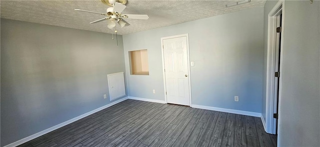 spare room featuring ceiling fan, dark hardwood / wood-style floors, and a textured ceiling