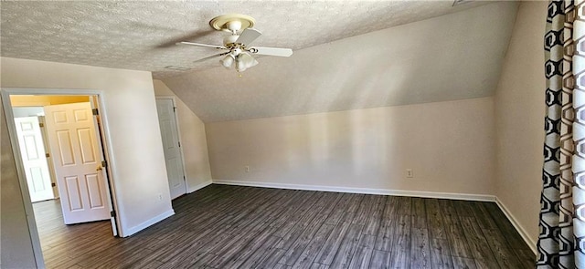 bonus room with a textured ceiling, dark wood-type flooring, and vaulted ceiling