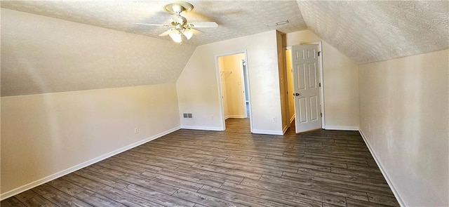 additional living space featuring dark hardwood / wood-style floors, ceiling fan, and a textured ceiling