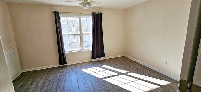 spare room with ceiling fan and dark hardwood / wood-style flooring