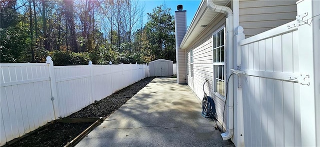 view of home's exterior with a storage unit and a patio area