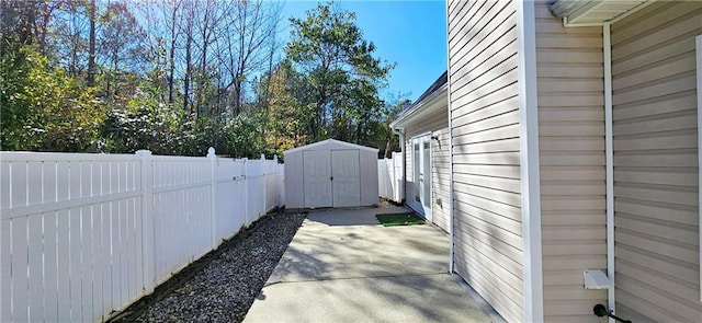 view of side of property with a storage unit and a patio