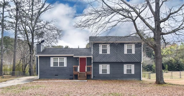 split level home with crawl space, a chimney, and fence