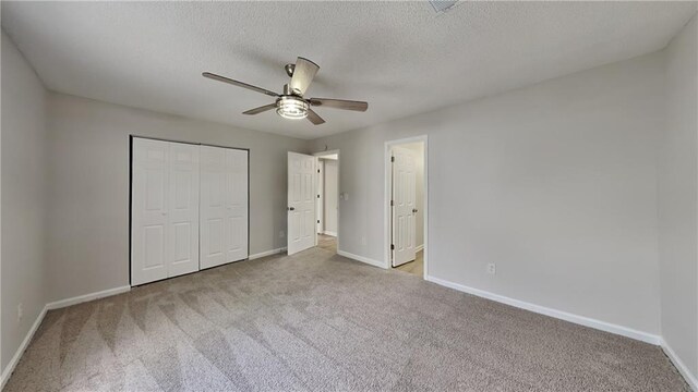 unfurnished bedroom featuring carpet flooring, baseboards, and a closet