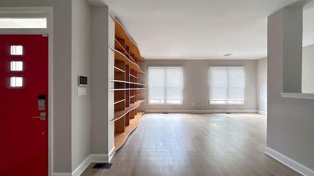 interior space with baseboards and wood finished floors