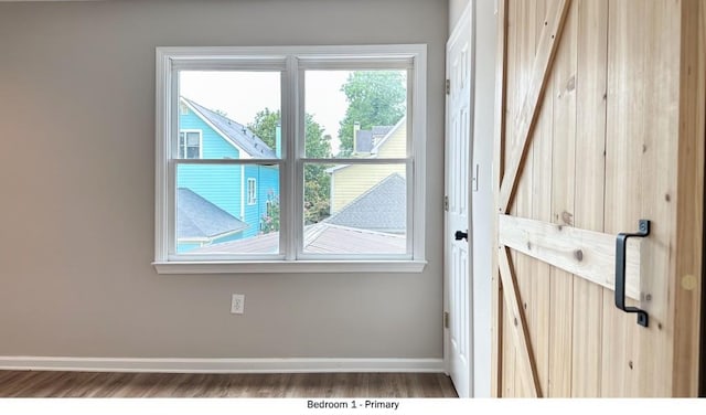 entryway featuring baseboards and wood finished floors