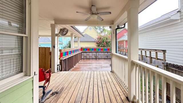 wooden deck featuring ceiling fan