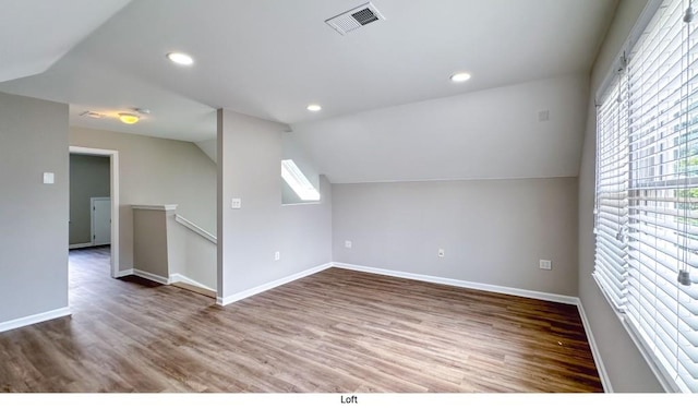 bonus room with recessed lighting, wood finished floors, visible vents, baseboards, and vaulted ceiling