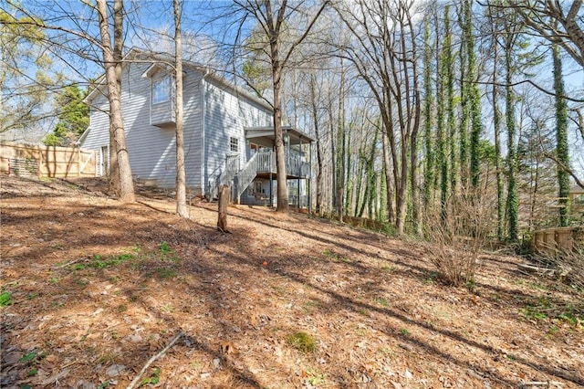 view of yard with stairs and fence