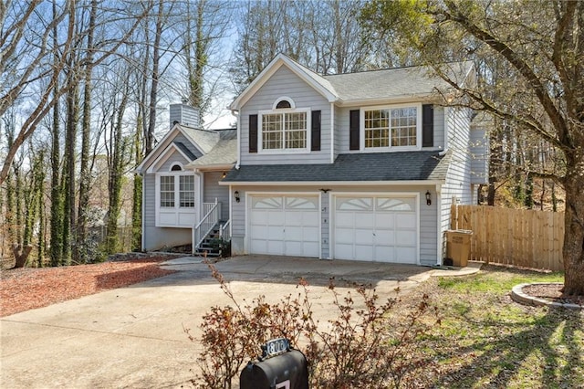 view of front of home featuring fence, driveway, a shingled roof, a chimney, and a garage