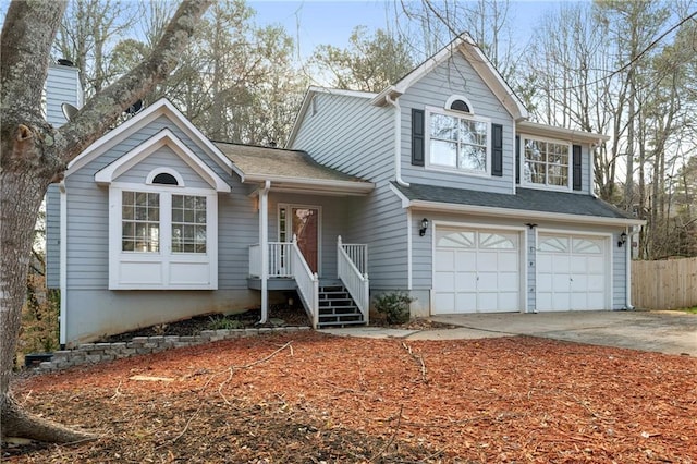 view of front of house featuring a garage, roof with shingles, driveway, and fence