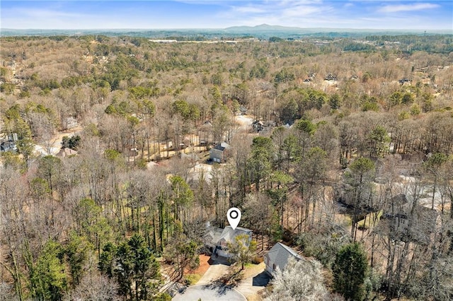 drone / aerial view featuring a forest view