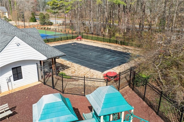 view of swimming pool with a patio area and fence