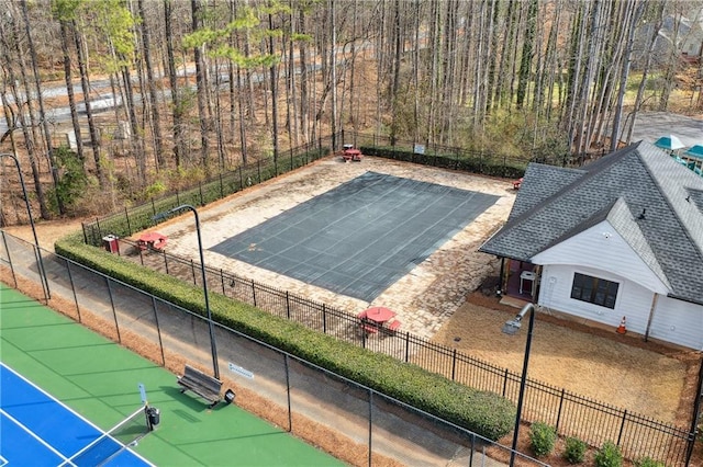 view of sport court featuring fence