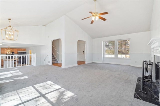 unfurnished living room with arched walkways, a fireplace, high vaulted ceiling, and carpet floors