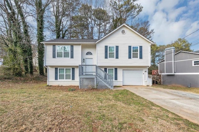 raised ranch with a front yard and a garage