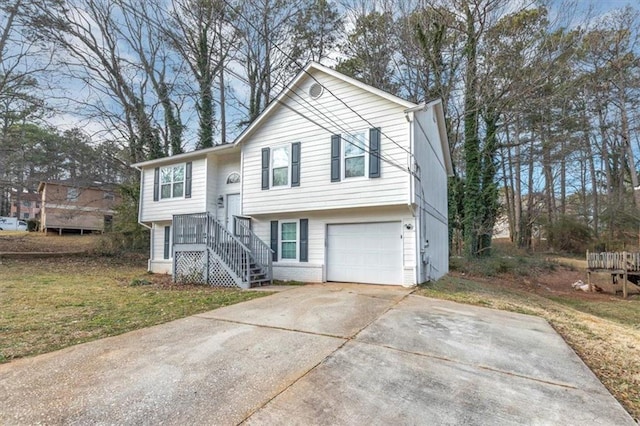 bi-level home featuring a front lawn and a garage