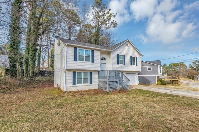 raised ranch with a front yard and a garage