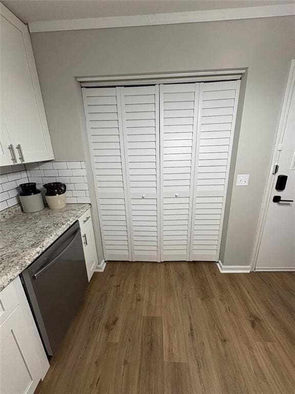 38 Daniel Cir, Franklin, GA 30217 - kitchen with stainless steel dishwasher, dark wood-style floors, decorative backsplash, white cabinetry, and crown molding