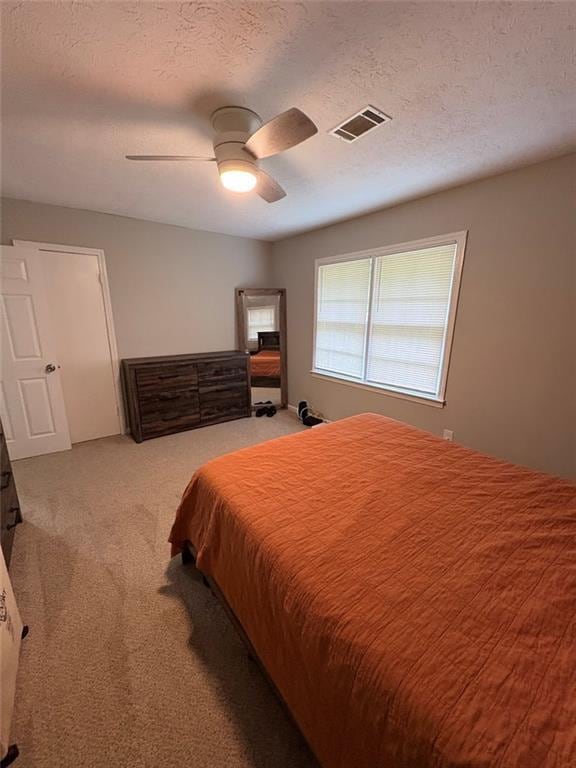 38 Daniel Cir, Franklin, GA 30217 - bedroom with carpet floors, ceiling fan, and a textured ceiling