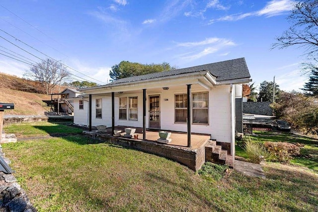 bungalow-style house with covered porch and a front yard