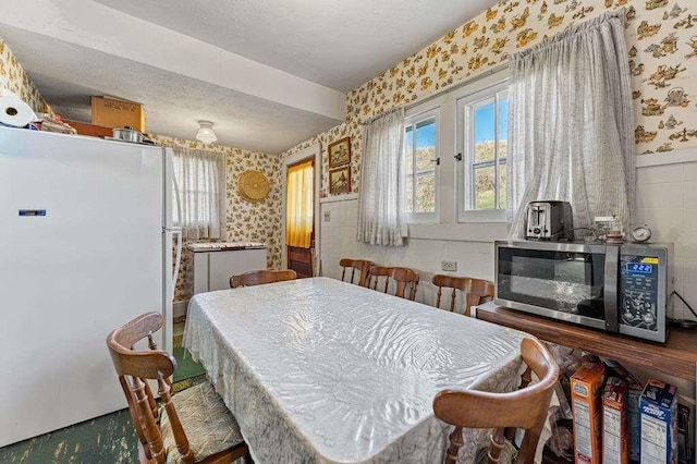 dining space with a textured ceiling