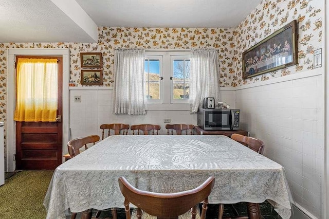 dining space featuring carpet floors and plenty of natural light