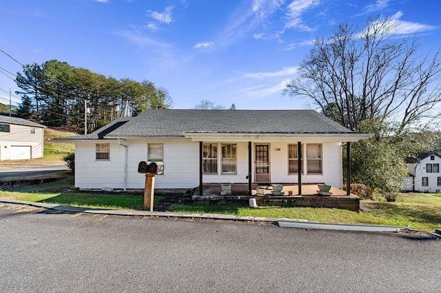 view of front of home with a porch and a front yard